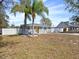 Attractive one story home featuring a vibrant yellow front door and meticulously maintained landscaping at 3764 Pinehurst St, Deltona, FL 32738