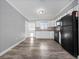 Open eat-in kitchen featuring white cabinetry, a black appliance suite, and plenty of counter space at 3764 Pinehurst St, Deltona, FL 32738