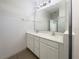 Bathroom with a double sink vanity, large mirror, and a tiled shower at 3882 Crawley Down Loop, Sanford, FL 32773