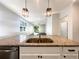 Modern kitchen with granite countertops, stainless steel sink and a view to the living room at 3882 Crawley Down Loop, Sanford, FL 32773