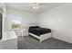 Bright bedroom featuring a modern ceiling fan, neutral walls, and a window providing natural light at 417 Ironside Trail Dr, Groveland, FL 34736