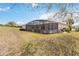 A screened lanai is attached to the house, offering indoor/outdoor living overlooking the spacious backyard at 4724 Sable Ridge Ct, Leesburg, FL 34748