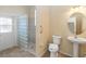 Bathroom featuring a glass block shower, toilet, and pedestal sink for a modern look at 4724 Sable Ridge Ct, Leesburg, FL 34748