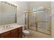 Classic bathroom showcasing vanity with framed mirror and a shower with gold frame at 4724 Sable Ridge Ct, Leesburg, FL 34748