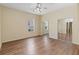 Bright bedroom featuring gleaming hardwood floors and mirrored closet doors for extra space at 4724 Sable Ridge Ct, Leesburg, FL 34748