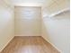 Walk-in closet with ample shelving and a small window, offering plenty of storage space at 4724 Sable Ridge Ct, Leesburg, FL 34748