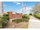 Sable Ridge Village entrance sign features a brick pillar with manicured landscaping and an American flag at 4724 Sable Ridge Ct, Leesburg, FL 34748