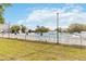 A community pool with a white fence, umbrellas, and chairs surrounds the large outdoor pool area at 4724 Sable Ridge Ct, Leesburg, FL 34748