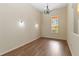 Elegant dining room with hardwood flooring, chandelier, and bright natural light at 4724 Sable Ridge Ct, Leesburg, FL 34748