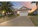 Inviting single-Gathering home with a two-car garage, enhanced by lush landscaping and a warm, colorful sunset backdrop at 4724 Sable Ridge Ct, Leesburg, FL 34748