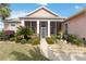 Beautiful home featuring a screened porch, decorative fountain, and mature landscaping at 4724 Sable Ridge Ct, Leesburg, FL 34748