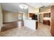 Open concept living room and kitchen area with tile flooring and natural light from the exterior window at 4724 Sable Ridge Ct, Leesburg, FL 34748