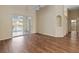 Open-concept living room with hardwood flooring, ceiling fan, and access to the screened lanai at 4724 Sable Ridge Ct, Leesburg, FL 34748