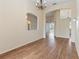 Open-concept living room with hardwood flooring, arched doorways, and natural light at 4724 Sable Ridge Ct, Leesburg, FL 34748