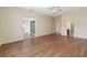 Expansive living room featuring hardwood floors, ceiling fan, and seamless transition to other areas at 4724 Sable Ridge Ct, Leesburg, FL 34748