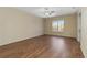 Bright living room showcasing hardwood floors and a window offering natural light and views at 4724 Sable Ridge Ct, Leesburg, FL 34748