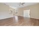 Spacious living room featuring hardwood flooring, a ceiling fan, and access to other rooms in the home at 4724 Sable Ridge Ct, Leesburg, FL 34748