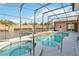 Inviting pool and spa with screened enclosure, perfect for relaxation and entertaining at 4724 Sable Ridge Ct, Leesburg, FL 34748