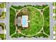 Aerial view showcasing a community pool and green space surrounded by neighborhood streets at 4796 Riverwalk Dr, St Cloud, FL 34771