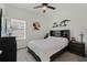 Comfortable bedroom with ceiling fan, stylish decor, and ample natural light at 4796 Riverwalk Dr, St Cloud, FL 34771