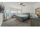 Bright bedroom with large windows, neutral decor, and comfortable furnishings at 4796 Riverwalk Dr, St Cloud, FL 34771