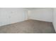 A large, empty room with neutral carpet and white walls, showcasing the spaciousness and potential of the living space at 4796 Riverwalk Dr, St Cloud, FL 34771