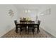 Dining room features a modern table and chairs set on a geometric-patterned rug, bathed in soft, natural light at 4796 Riverwalk Dr, St Cloud, FL 34771