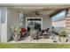 Cozy covered patio with wicker furniture, a ceiling fan, and a peaceful view of the well-maintained backyard at 4796 Riverwalk Dr, St Cloud, FL 34771