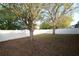 Spacious backyard featuring mature trees, a well-maintained lawn, and a white vinyl fence at 4852 Blue Major Dr, Windermere, FL 34786