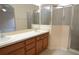 Spacious bathroom features double sinks, wood cabinets and a glass door shower at 4852 Blue Major Dr, Windermere, FL 34786