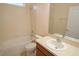 A well-maintained bathroom featuring a vanity, toilet, and a bathtub with tiled walls at 4852 Blue Major Dr, Windermere, FL 34786