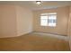 Bright bedroom features neutral carpet, ample natural light from a large window at 4852 Blue Major Dr, Windermere, FL 34786