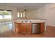 Bright kitchen featuring a stainless steel dishwasher, wood cabinets, and a dual sink under the window at 4852 Blue Major Dr, Windermere, FL 34786