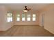 Bright living room with a ceiling fan and large windows with views of the front yard at 4852 Blue Major Dr, Windermere, FL 34786