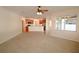 Open-concept living room with light-colored carpet, and view of the kitchen and dining area at 4852 Blue Major Dr, Windermere, FL 34786