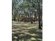 Community playground featuring play structures surrounded by mature trees and well-maintained grassy areas at 5271 Images Cir # 303, Kissimmee, FL 34746