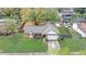 Aerial view of a single-Gathering home with well-manicured lawn and outdoor entertainment areas at 5444 Lighthouse Rd, Orlando, FL 32808