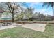 Enjoy this large backyard with an outdoor seating area, fire pit, and basketball court at 5444 Lighthouse Rd, Orlando, FL 32808