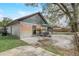 This backyard patio space has a lovely mural and outdoor furniture, creating a relaxing retreat at 5444 Lighthouse Rd, Orlando, FL 32808