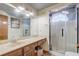 Bright bathroom featuring a vanity with dual sinks and a glass-enclosed shower at 5444 Lighthouse Rd, Orlando, FL 32808