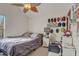 Bedroom with light walls, wood trim and a ceiling fan with leaf-shaped blades at 5444 Lighthouse Rd, Orlando, FL 32808