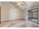 Bright bedroom with neutral paint, ceiling fan, and sliding glass door to a screened patio at 5444 Lighthouse Rd, Orlando, FL 32808