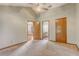 Bright bedroom with neutral paint, ceiling fan, and two open doorways offers great flow and flexibility at 5444 Lighthouse Rd, Orlando, FL 32808