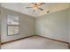 Neutral bedroom featuring a ceiling fan, carpeted floors, and natural light at 5444 Lighthouse Rd, Orlando, FL 32808
