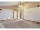 Spacious living room with vaulted ceiling, neutral carpet, and multiple doorways at 5444 Lighthouse Rd, Orlando, FL 32808