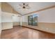 A spacious living room with hardwood floors and neutral walls features large window and vaulted ceilings at 5444 Lighthouse Rd, Orlando, FL 32808