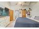 The bright primary bedroom with a ceiling fan has a large bed, dresser, and an ensuite bathroom at 5444 Lighthouse Rd, Orlando, FL 32808