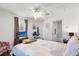 Bedroom featuring neutral colors, ceiling fan, and private bathroom at 5676 Gulf Stream St, Tavares, FL 32778