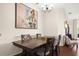 Inviting dining room with hardwood floors, stylish chandelier, and a large painting creating a focal point at 5676 Gulf Stream St, Tavares, FL 32778