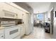 White kitchen appliances complement tile floors; breakfast nook is brightly lit at 5676 Gulf Stream St, Tavares, FL 32778